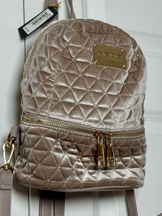 bebe velvet mini backpack Maria Quilted Blush Fashion Featuring single top handle top tab zip closure detachable adjustable shoulder straps side pockets with pyramid stud detail metal logo plaque external tab zip pocket internal zip pocket and gold tone hardware Bebe Small Backpack - Bebe
